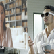 Man wearing smart glasses talks to woman on holographic video call